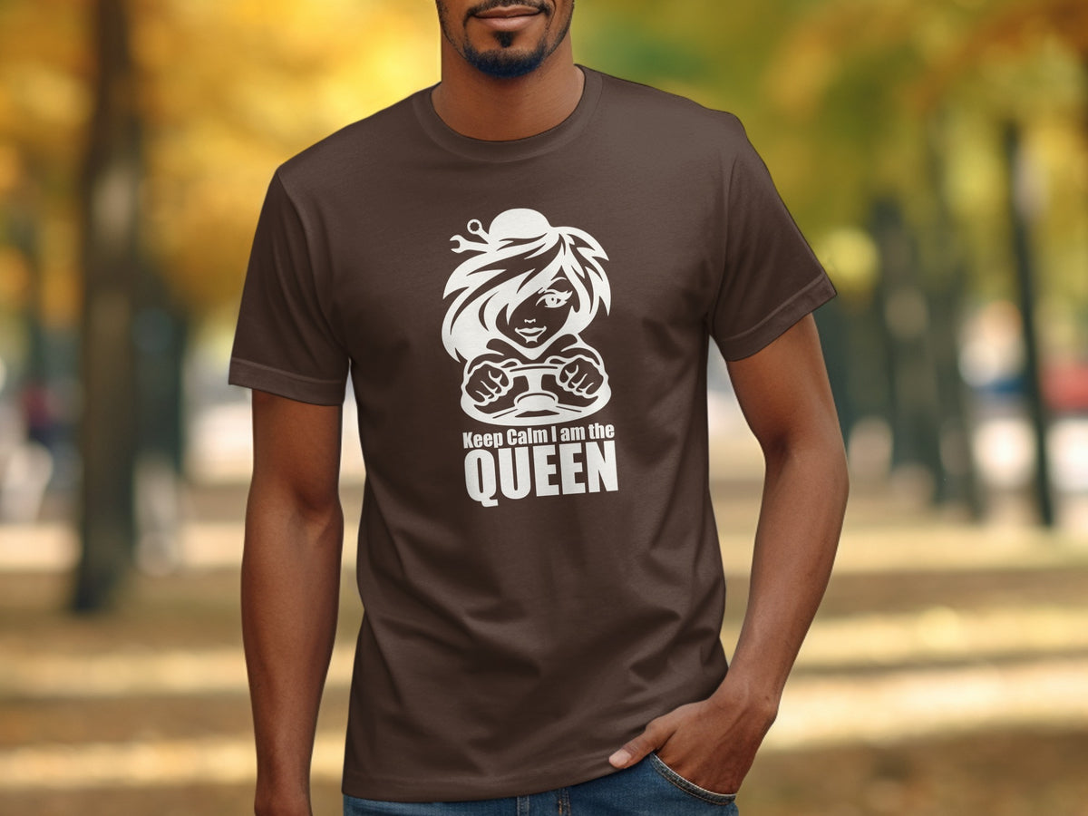 Brown t-shirt with white graphic of a woman driving and text "Keep Calm I am the QUEEN".