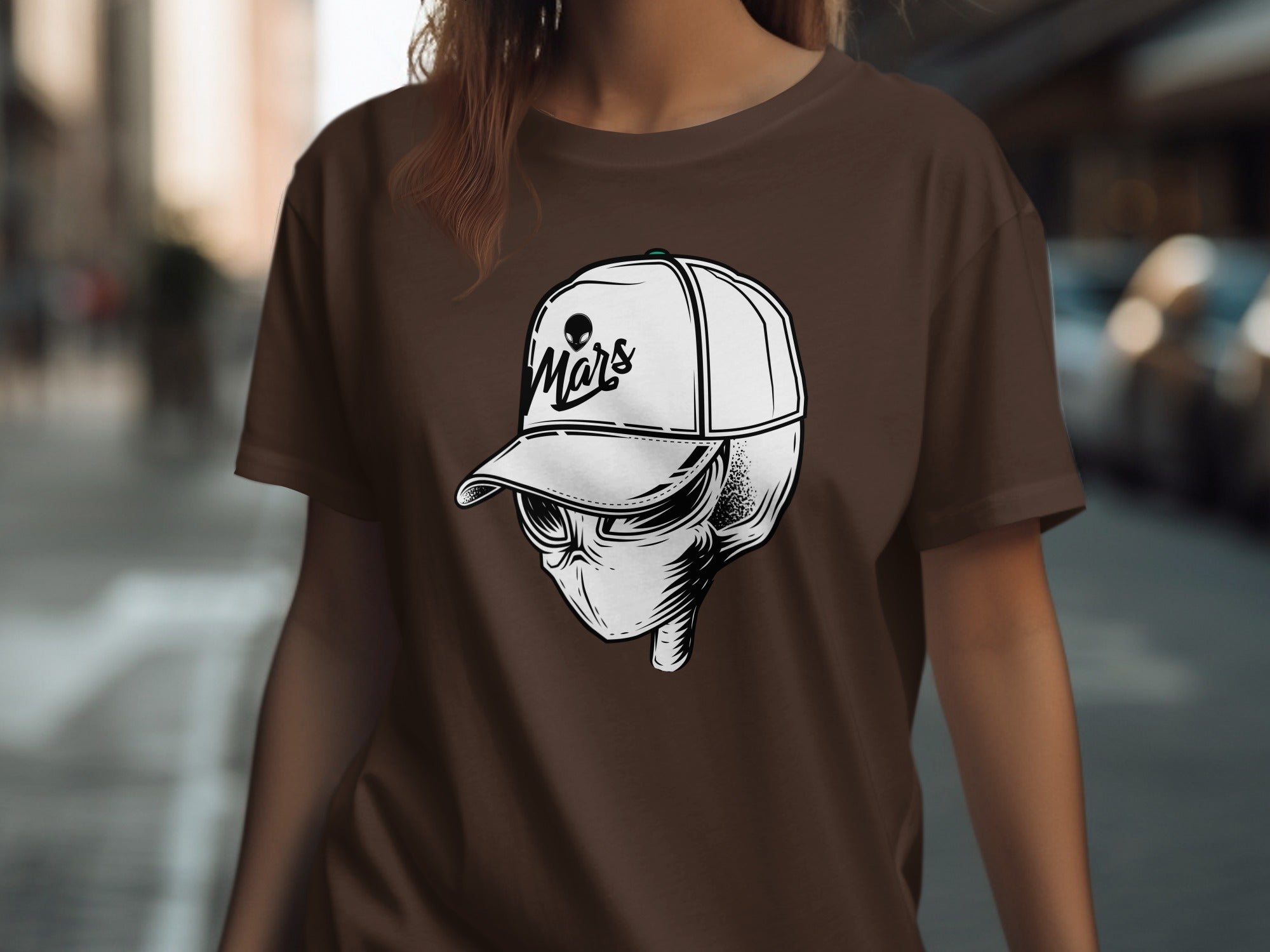 Brown t-shirt with white alien head wearing a baseball cap with "Mars" text.