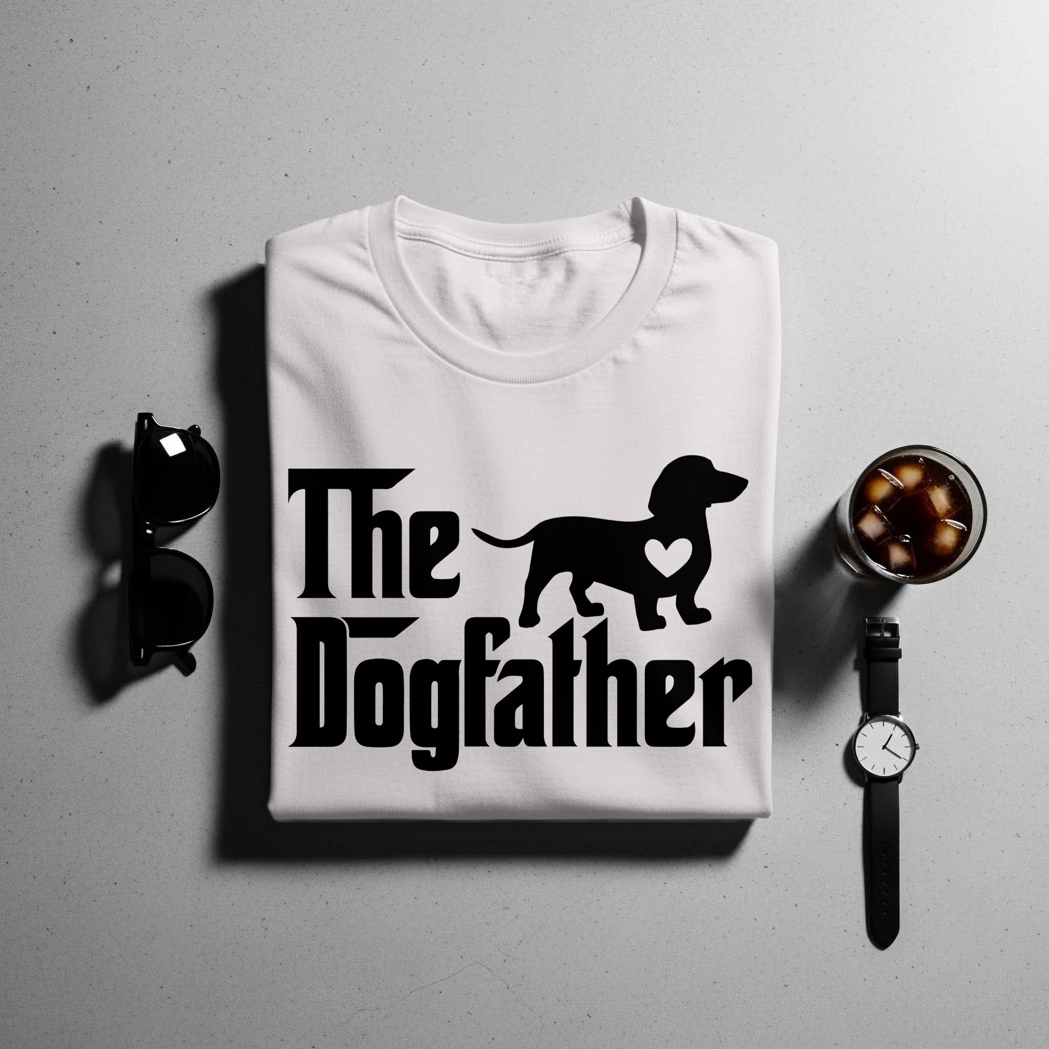 White t-shirt with "The Dogfather" text and a dachshund silhouette with a heart.