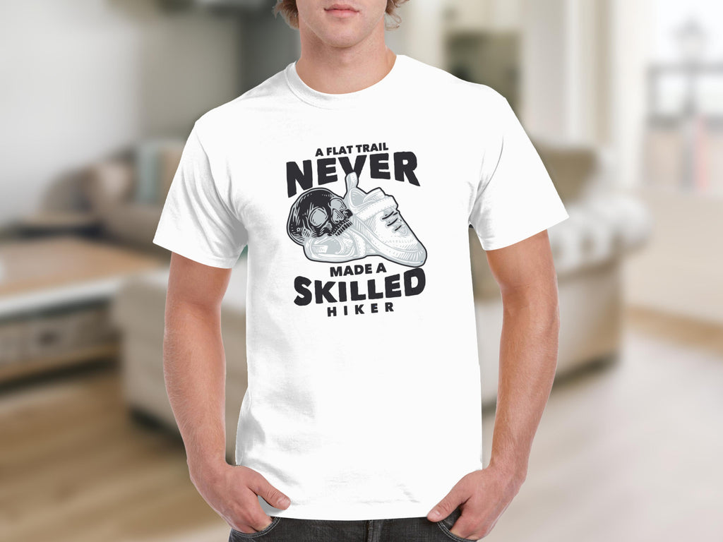 White t-shirt with graphic: A flat trail never made a skilled hiker.