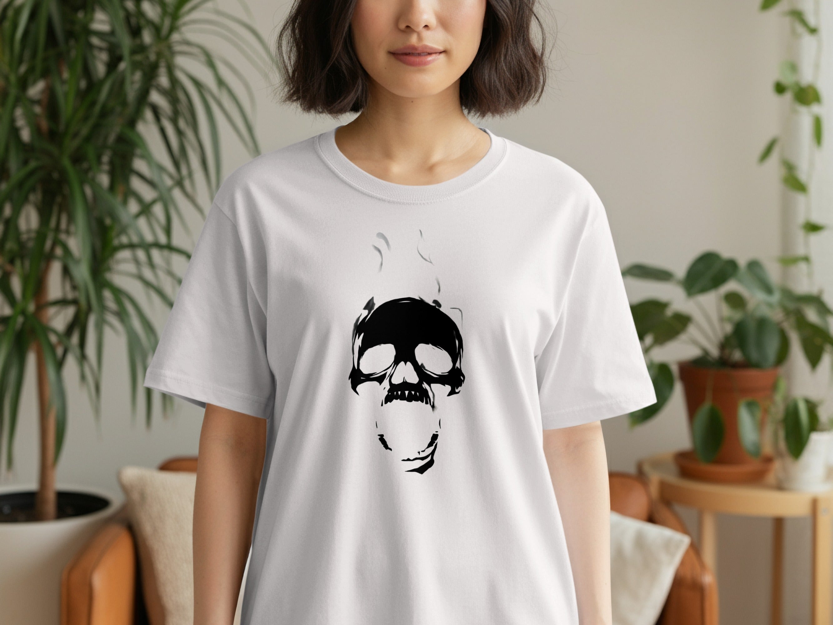 White t-shirt with a black, stylized skull graphic and smoke rising