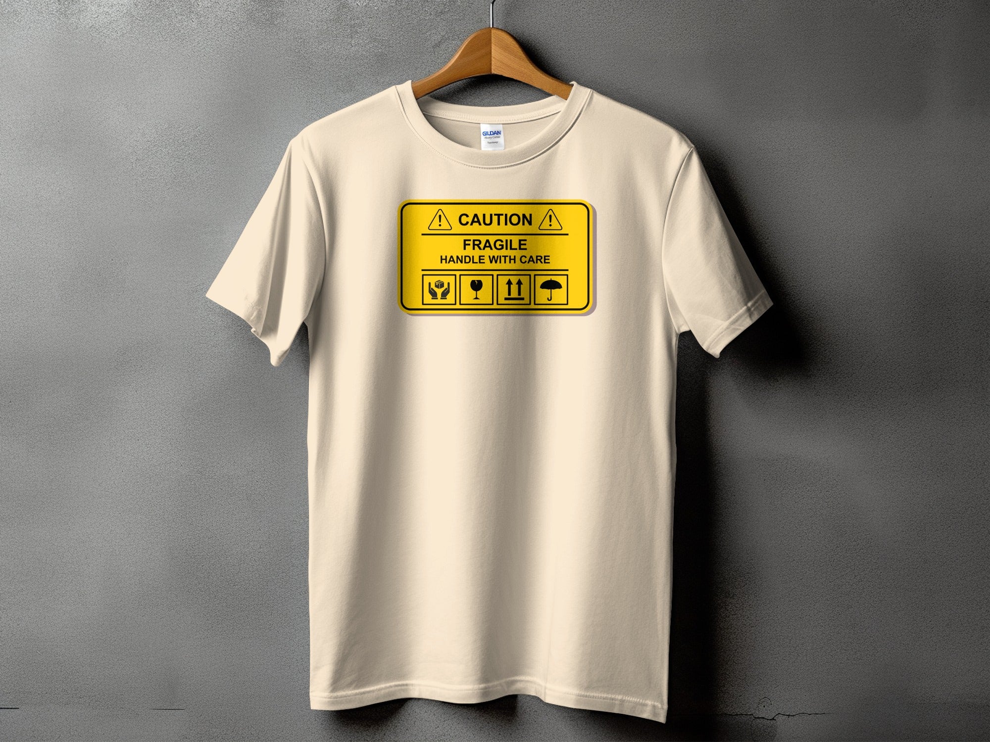 Cream t-shirt with "CAUTION FRAGILE HANDLE WITH CARE" and package symbols.