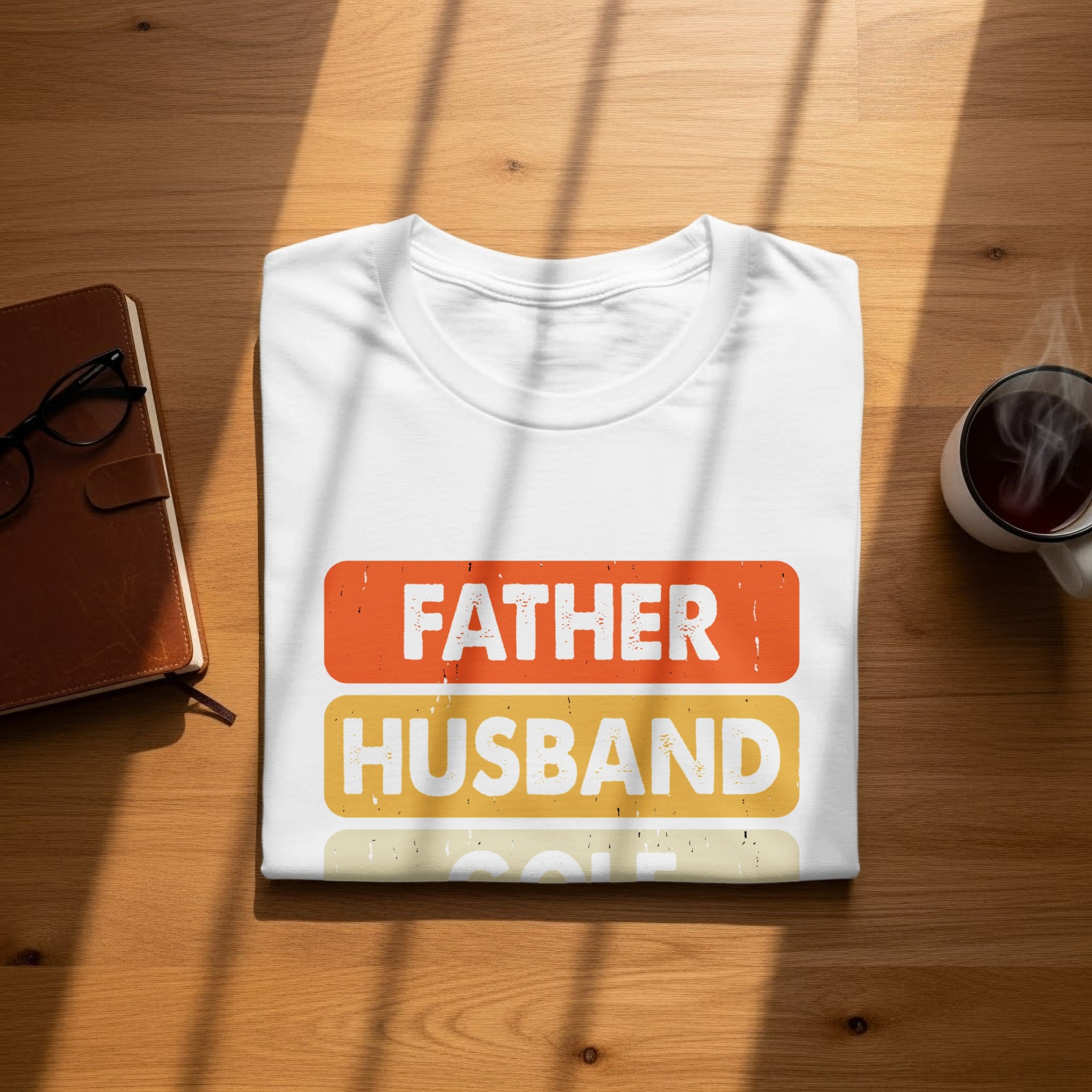 White t-shirt with "FATHER HUSBAND GOLF" text in colored block lettering.