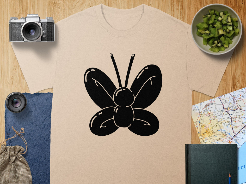 Beige t-shirt with black balloon butterfly graphic in center.