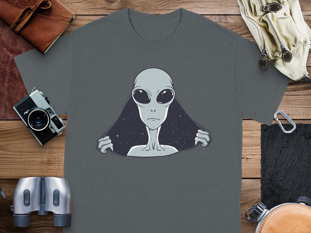 T-shirt with a grey alien peeking out from a starry background.