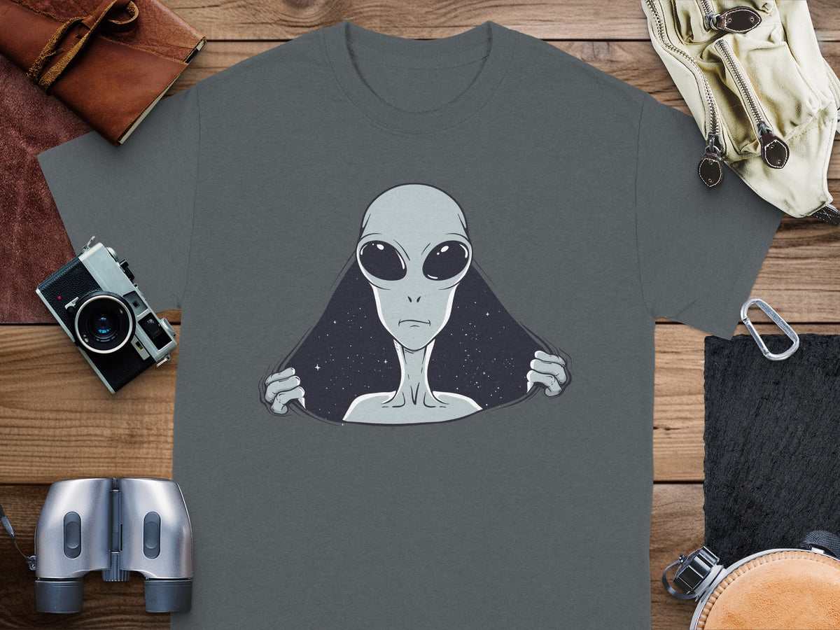 T-shirt with a grey alien peeking out from a starry background.