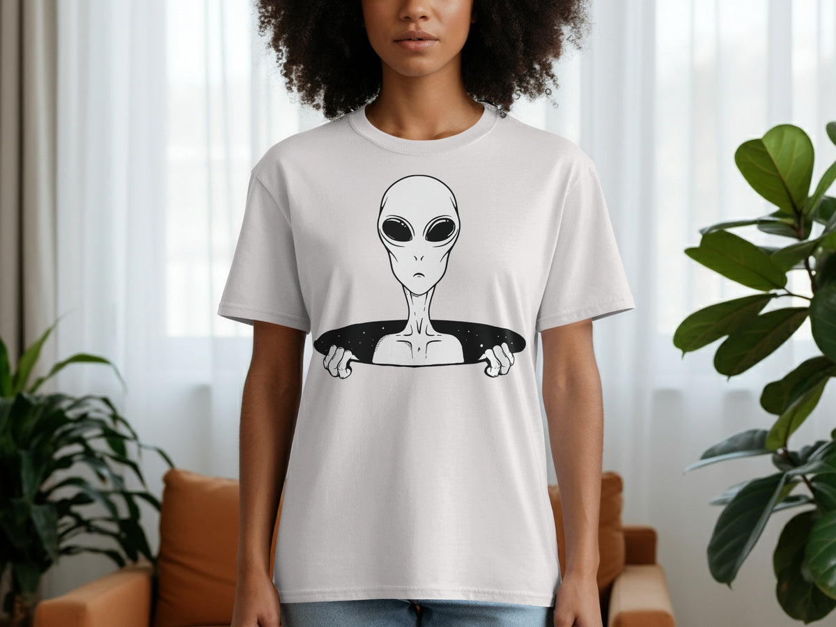 White t-shirt with black line art of a grey alien peeking through a black hole.