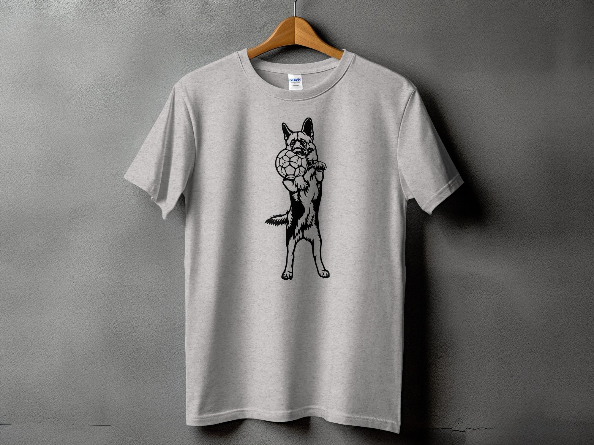 Light gray t-shirt with black graphic of a German Shepherd holding a soccer ball.