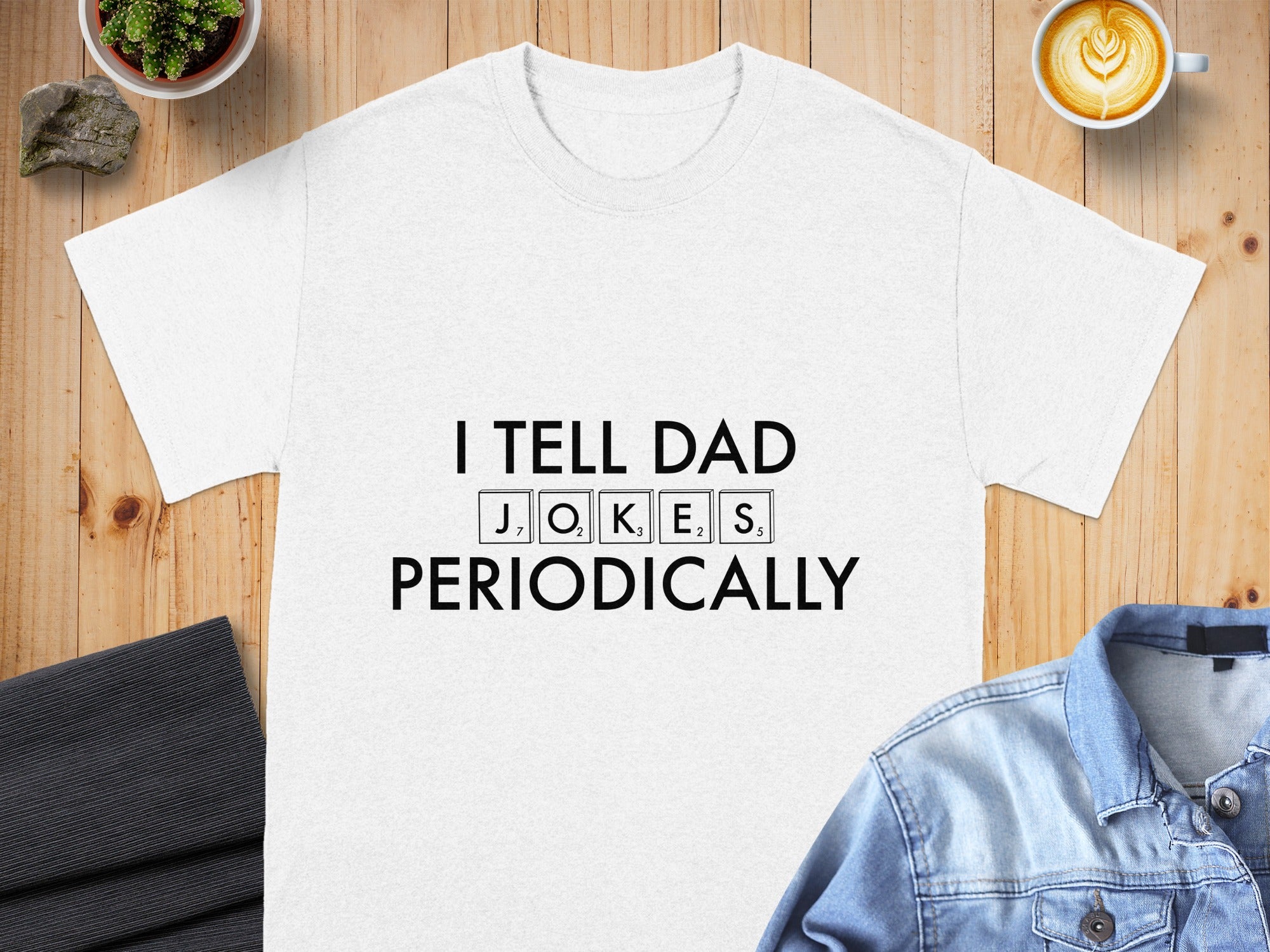 White t-shirt with "I TELL DAD JOKES PERIODICALLY" text using Scrabble tiles.