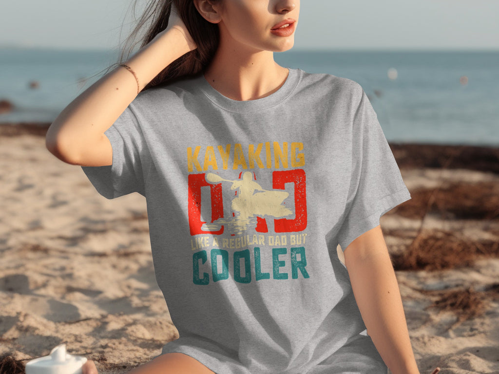 Grey t-shirt with "Kayaking Dad Like a regular dad but cooler" graphic.