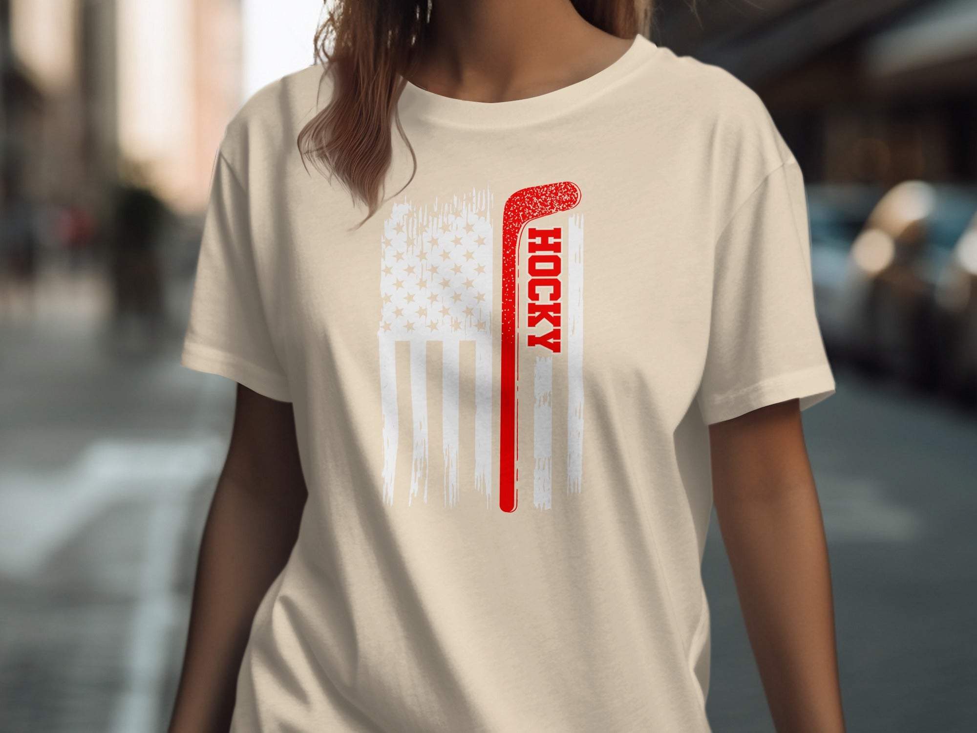 Cream t-shirt with distressed American flag and red hockey stick graphic.