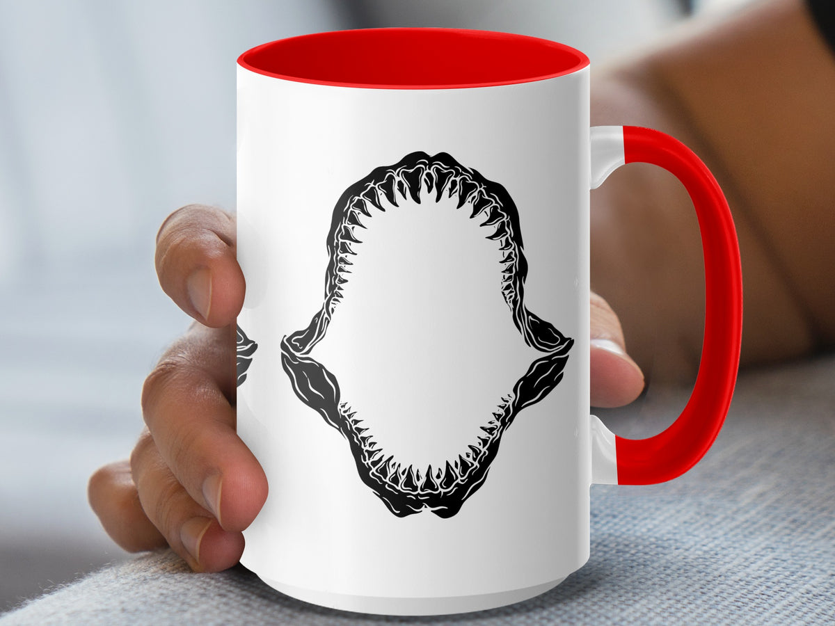 White mug with red interior and handle, featuring black shark jaws design.