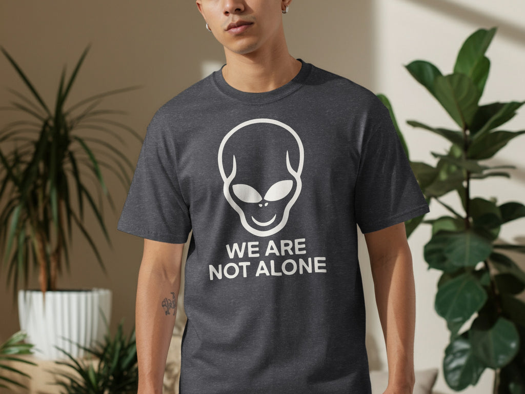Grey t-shirt with white alien graphic and text "WE ARE NOT ALONE".