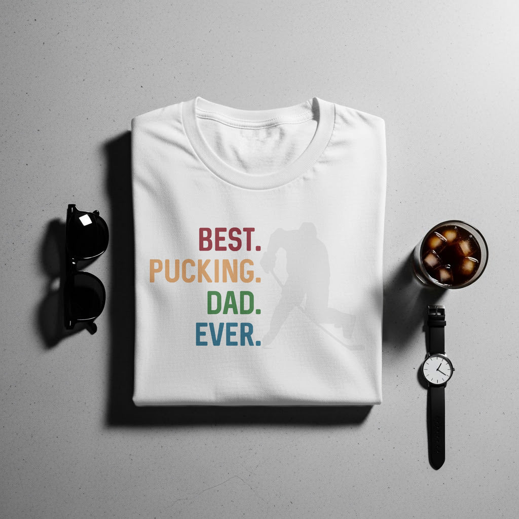 White t-shirt with "BEST. PUCKING. DAD. EVER." text and hockey player silhouette.