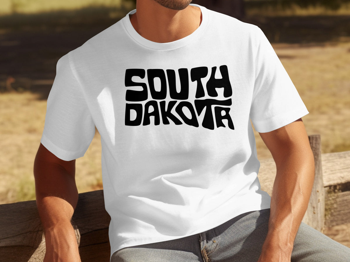 White t-shirt with bold black "SOUTH DAKOTA" text.