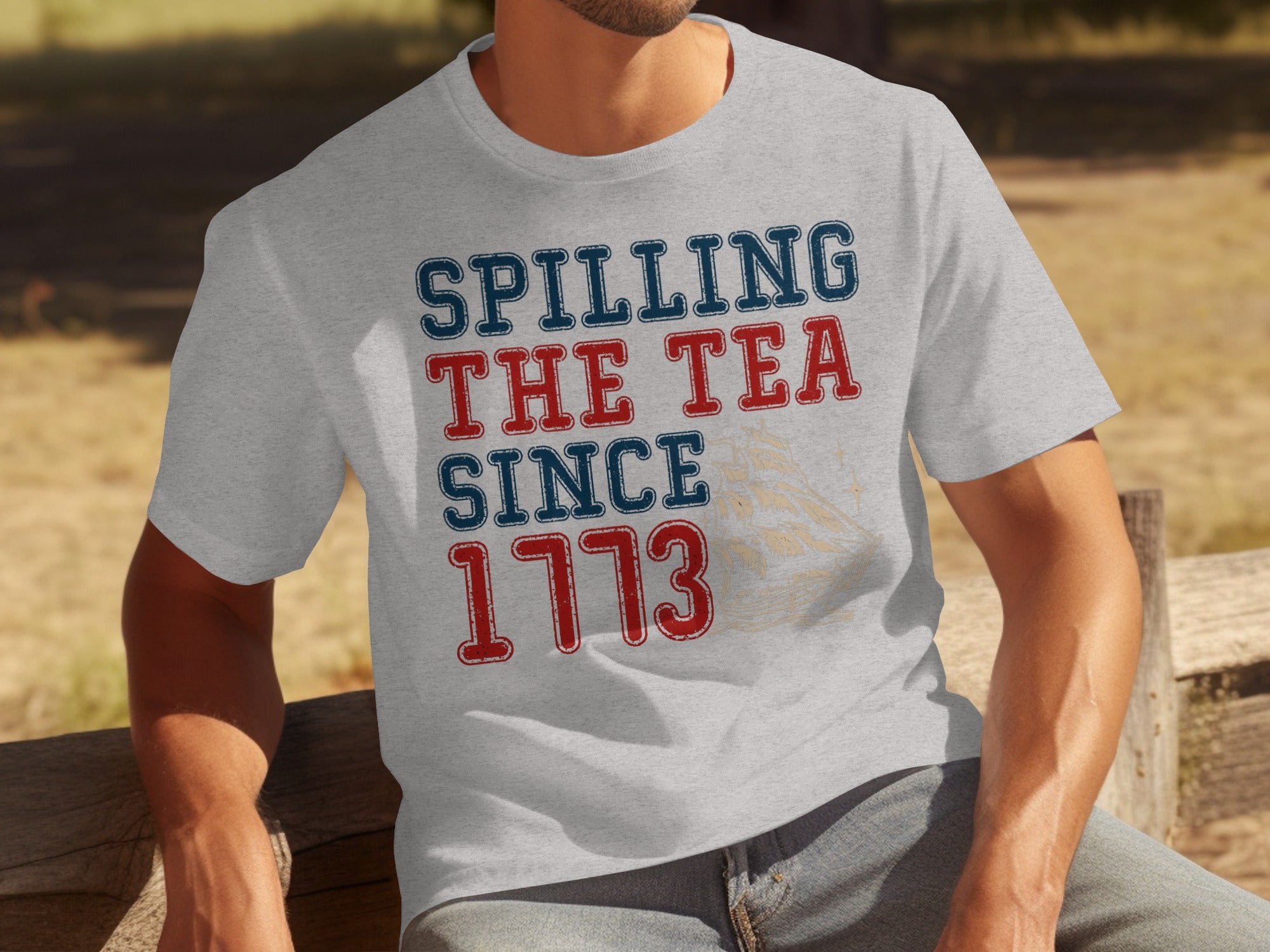 Light grey t-shirt with "Spilling The Tea Since 1773" text and ship graphic.