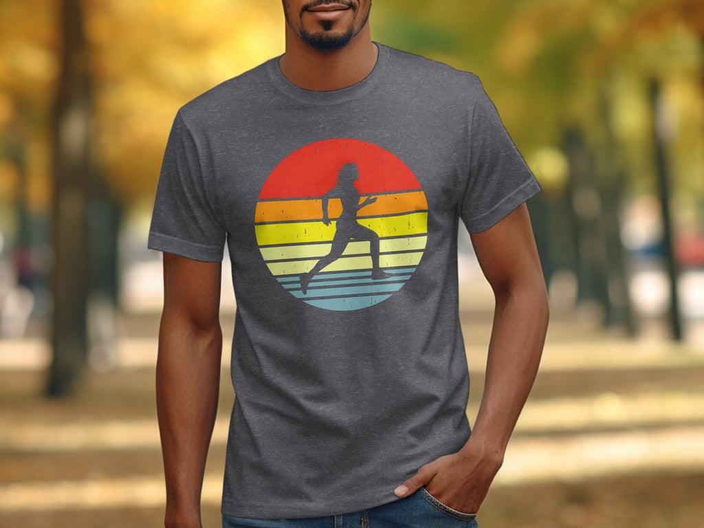 Dark gray t-shirt with a circular graphic of a runner against a retro sunset.