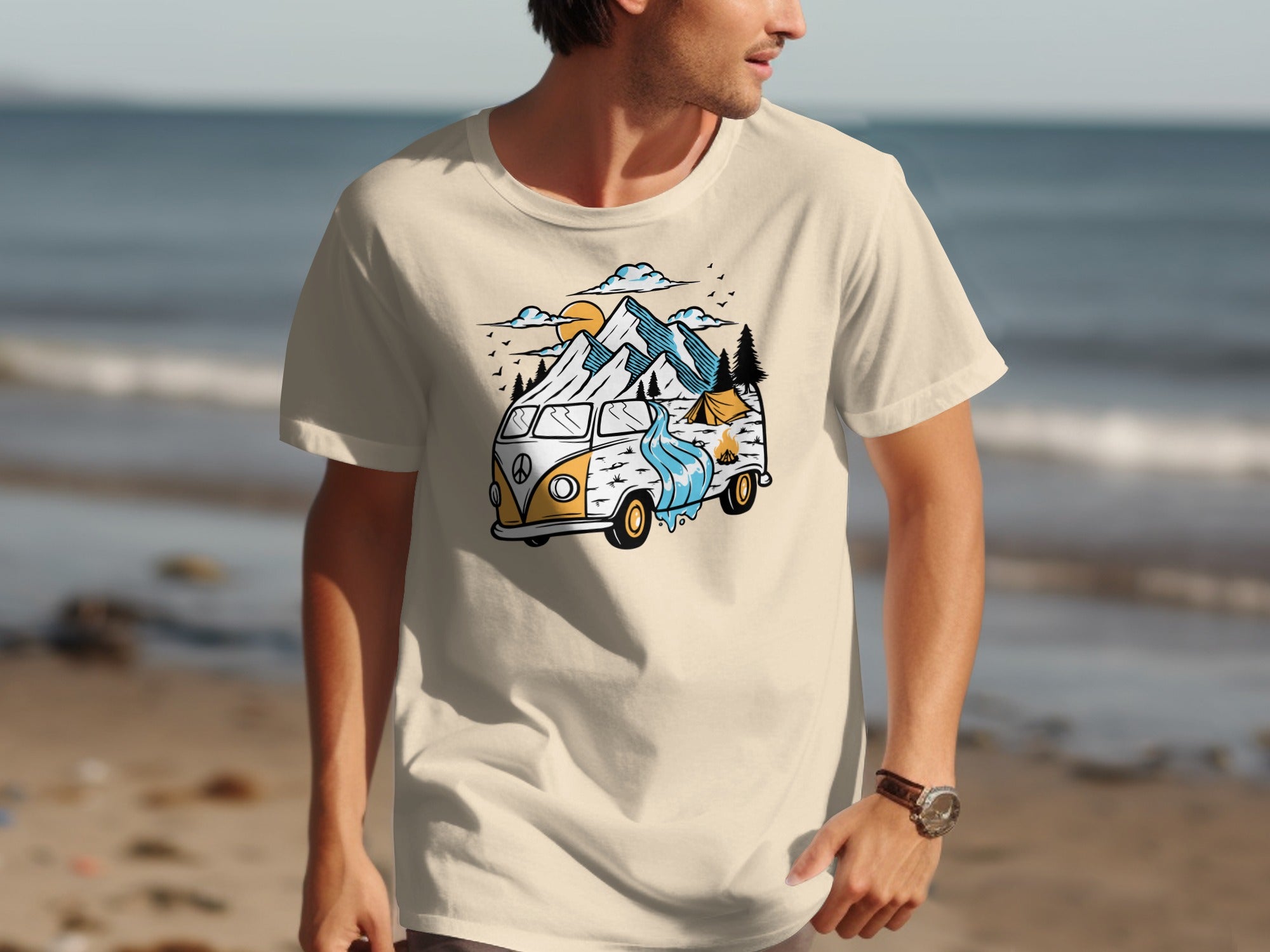 Cream t-shirt with graphic of a van, mountains, camping tent, and waterfall.