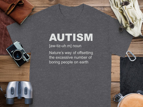 Autism definition on gray t-shirt, with camera and binoculars.