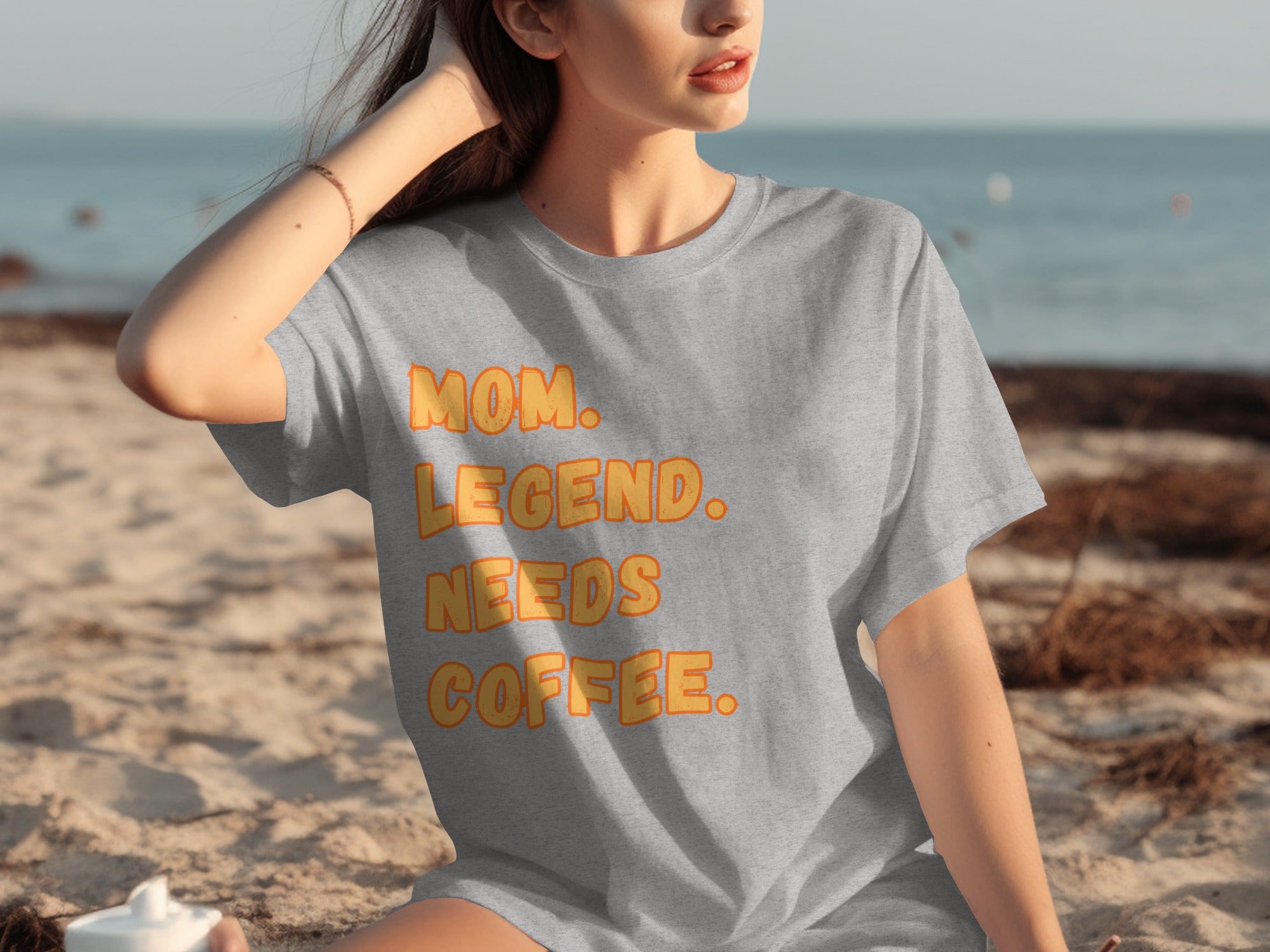 Grey t-shirt with orange text: Mom. Legend. Needs Coffee.