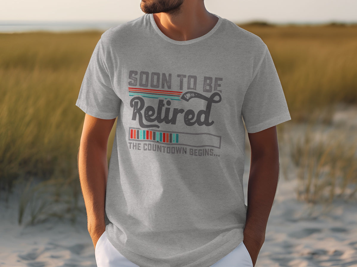 Grey t-shirt with "Soon to be Retired, The Countdown Begins..." graphic.