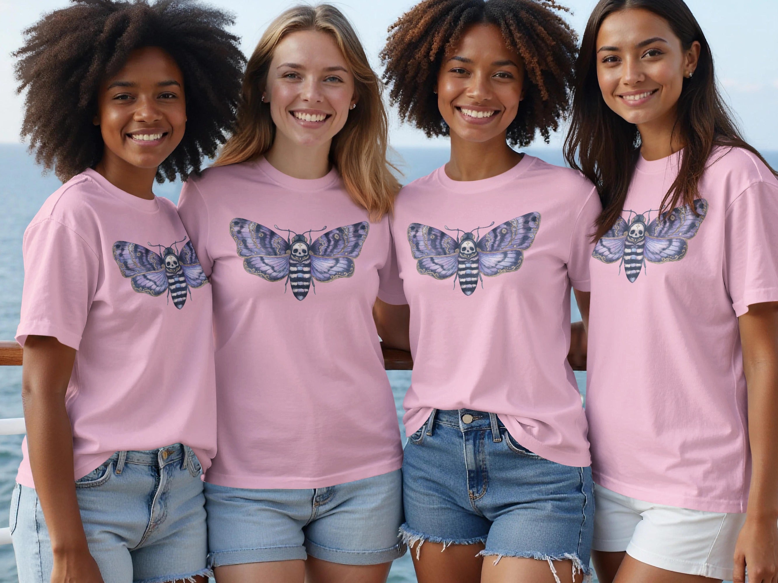 Four women wear pink t-shirts featuring a death's-head hawkmoth graphic.