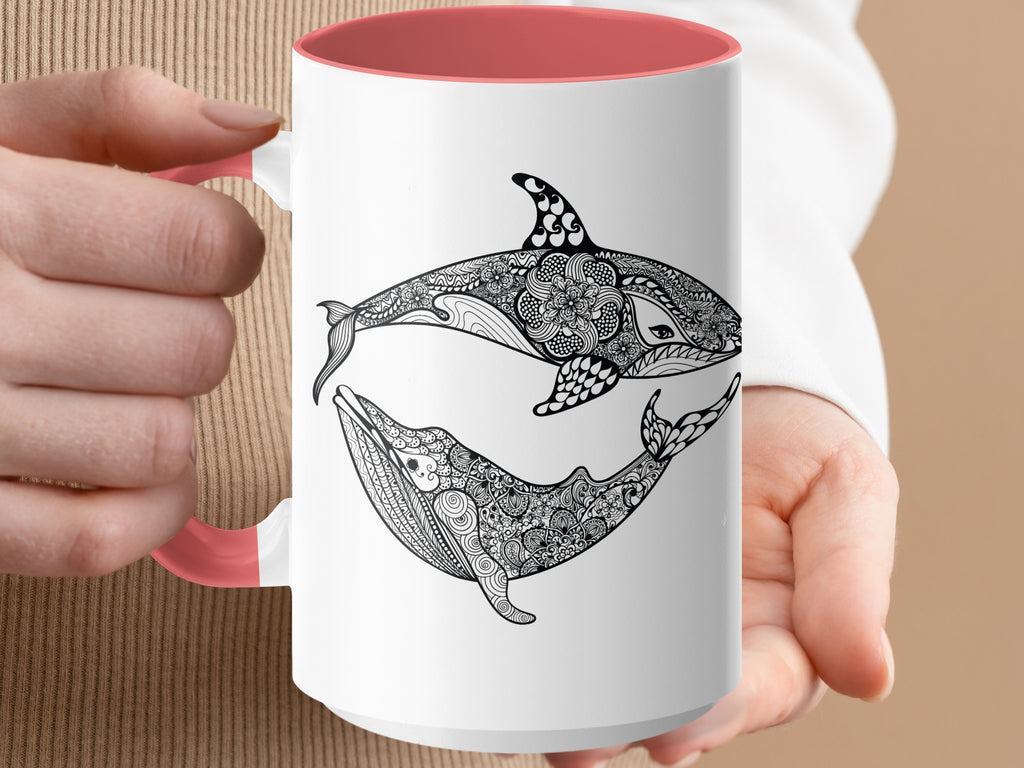 White mug with pink interior, featuring black ornamental orca and whale design.