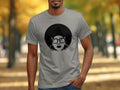 Gray t-shirt with a black graphic of a woman with an afro, glasses, and large hoop earrings.