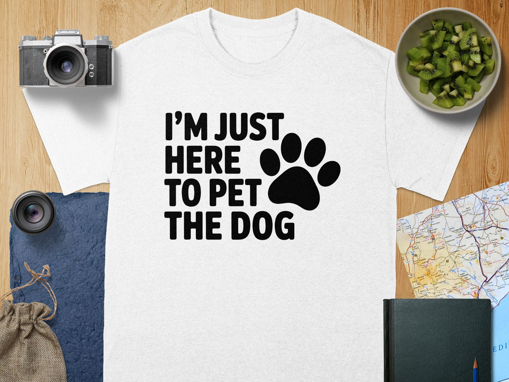 White t-shirt with black text "I'M JUST HERE TO PET THE DOG" and paw print.