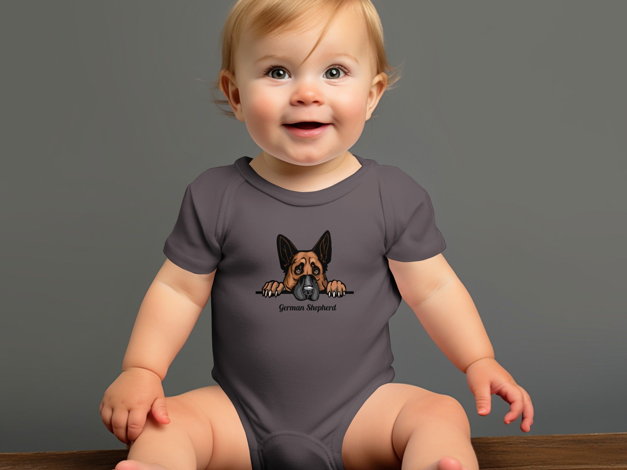 Baby in grey onesie with German Shepherd graphic and text.