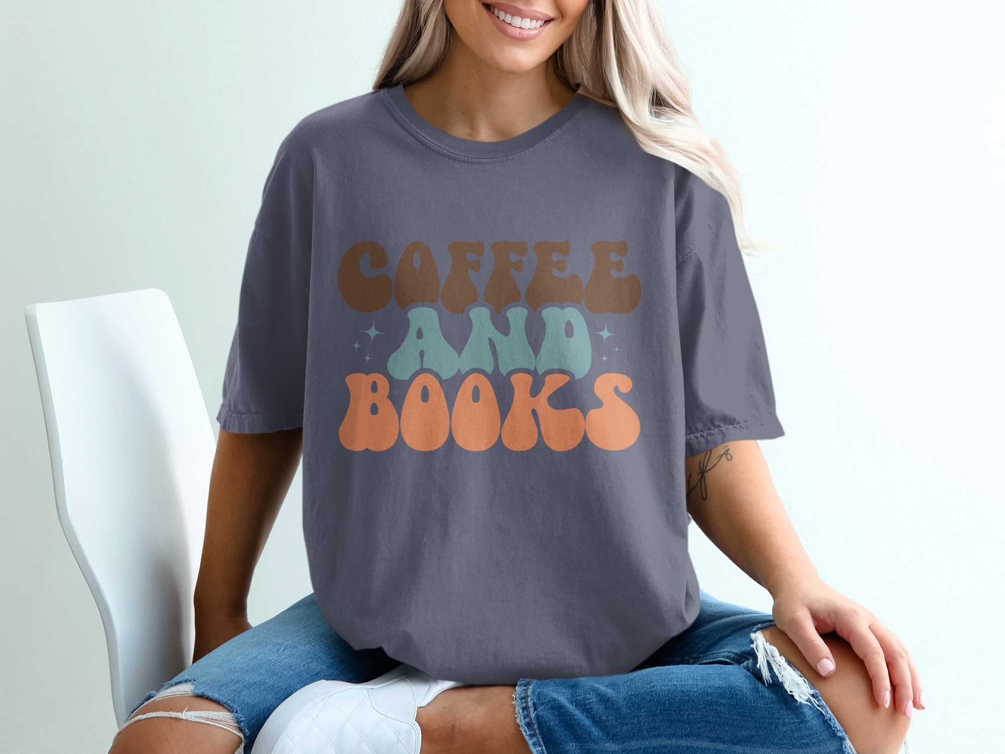 Dark grey t-shirt with "Coffee and Books" text in retro lettering.