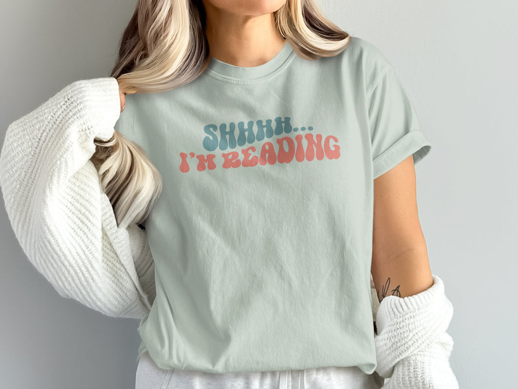 Light green t-shirt with "SHHHH... I'M READING" graphic in distressed blue and pink.