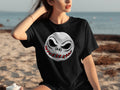 Black t-shirt with a stitched Jack Skellington face graphic on a beach.