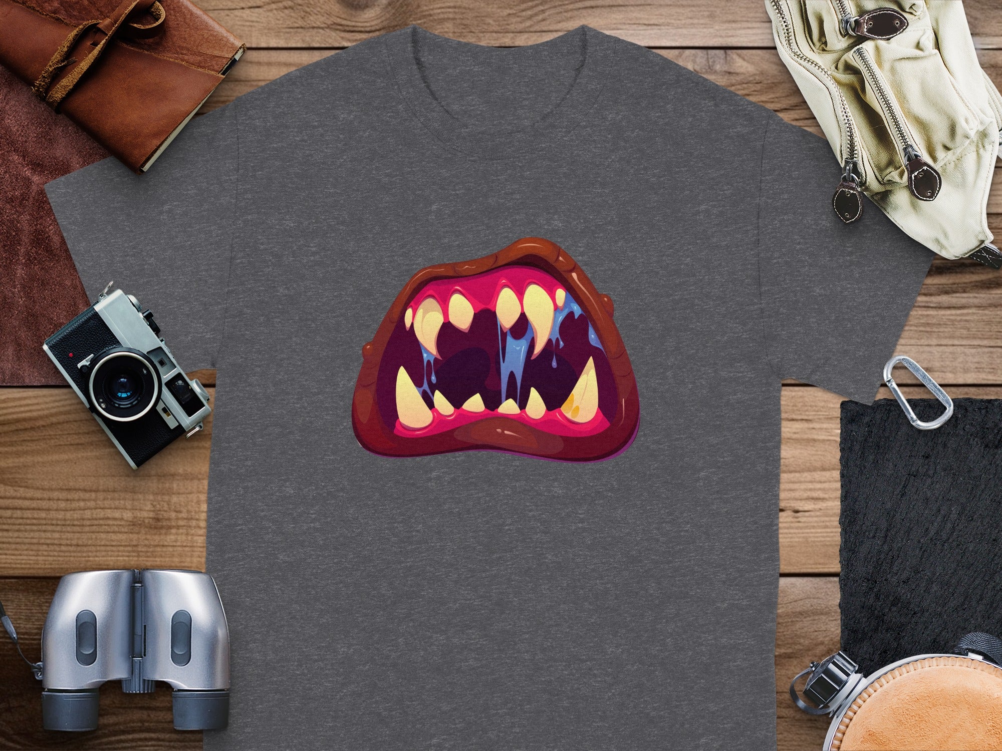 Dark grey t-shirt with a cartoon monster mouth graphic featuring sharp teeth and blue drool.