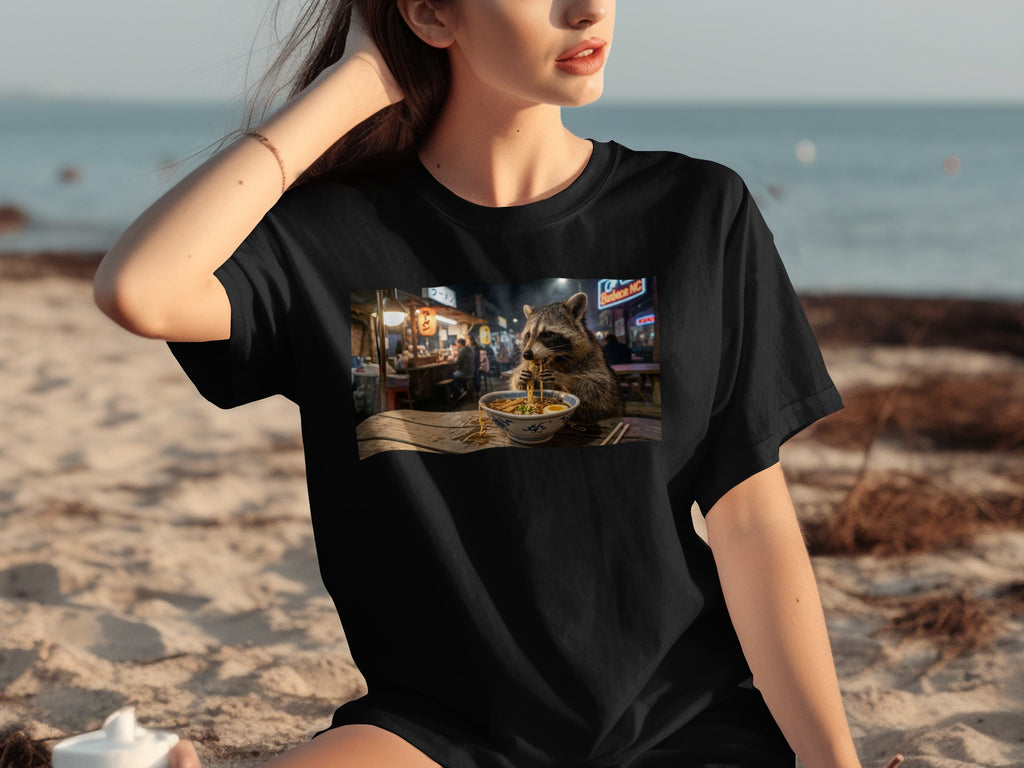T-shirt features a raccoon eating ramen in front of a Tokyo street scene.