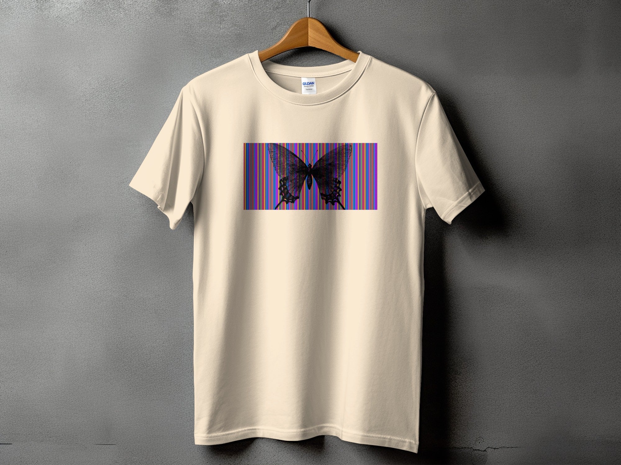 Cream t-shirt with a black butterfly on a striped background.