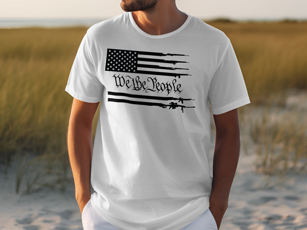 White t-shirt with American flag and guns graphic that says "We the People".