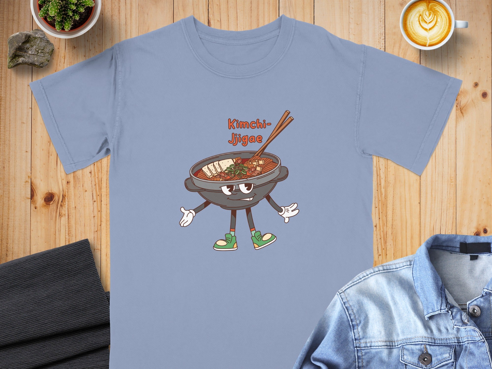 Light blue t-shirt with cartoon Kimchi Jjigae character graphic.