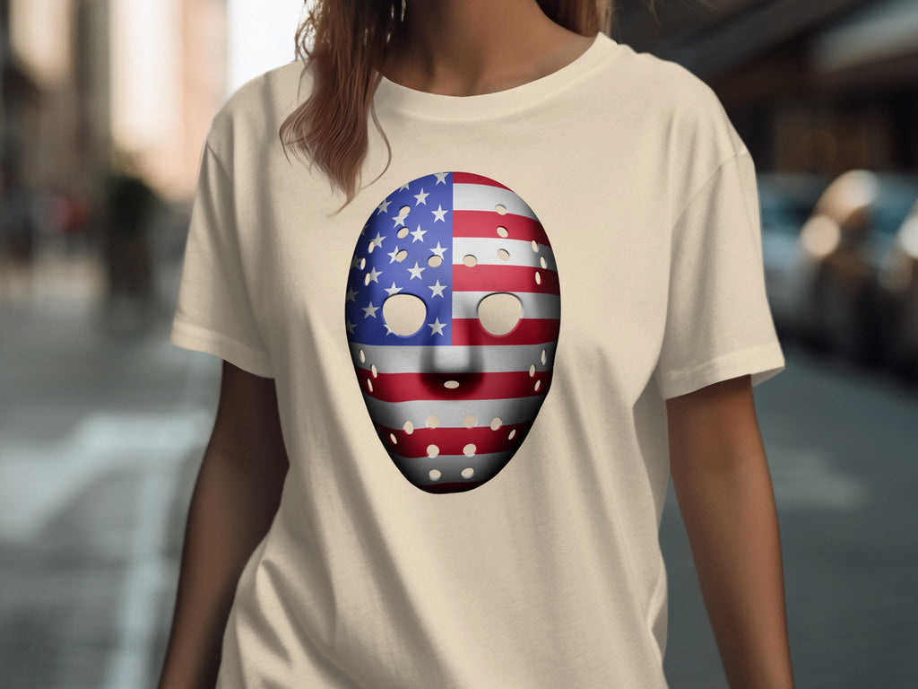 T-shirt with American flag hockey mask graphic on a light cream background.