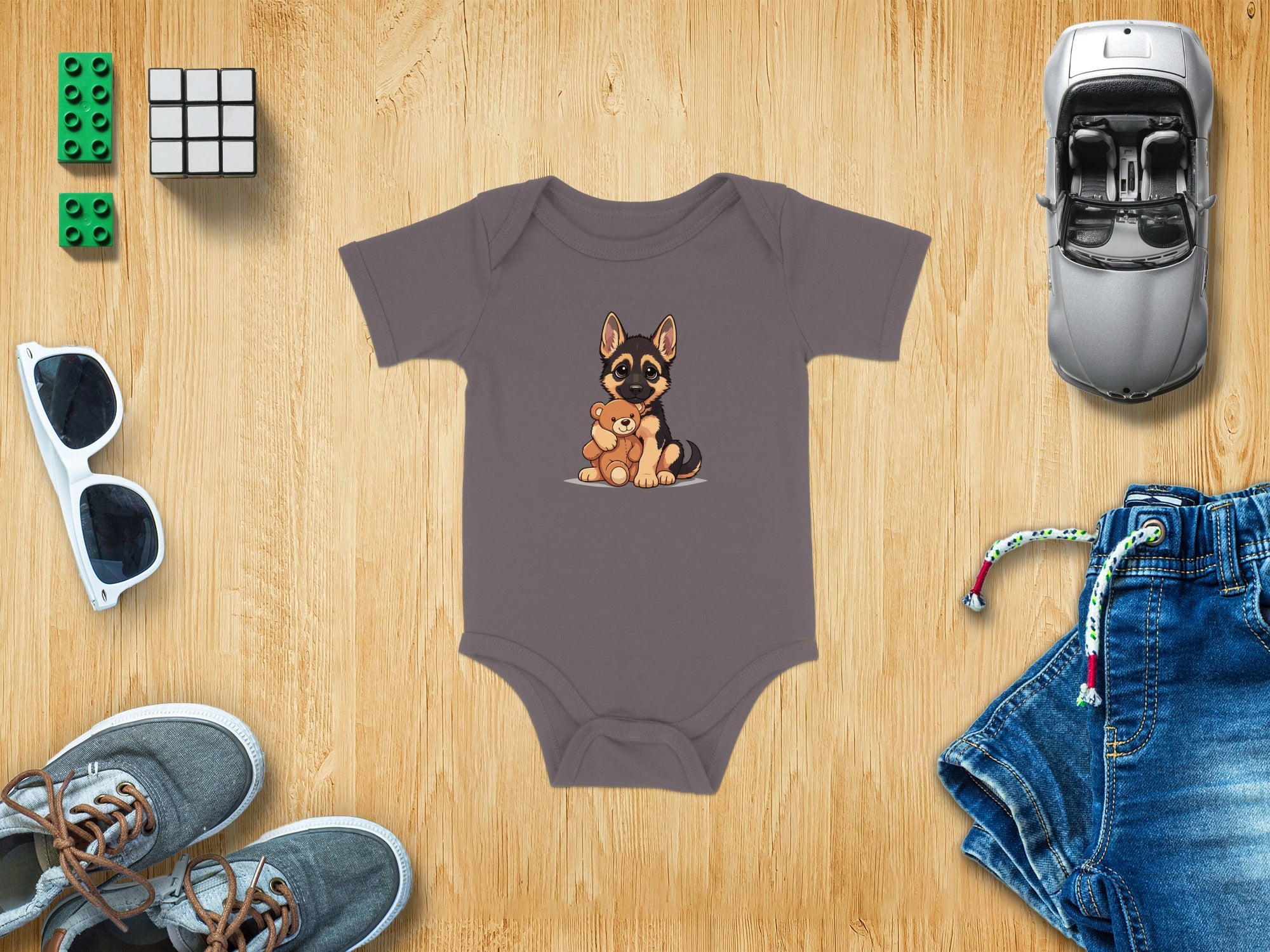 Gray baby onesie with a German Shepherd puppy holding a teddy bear graphic.