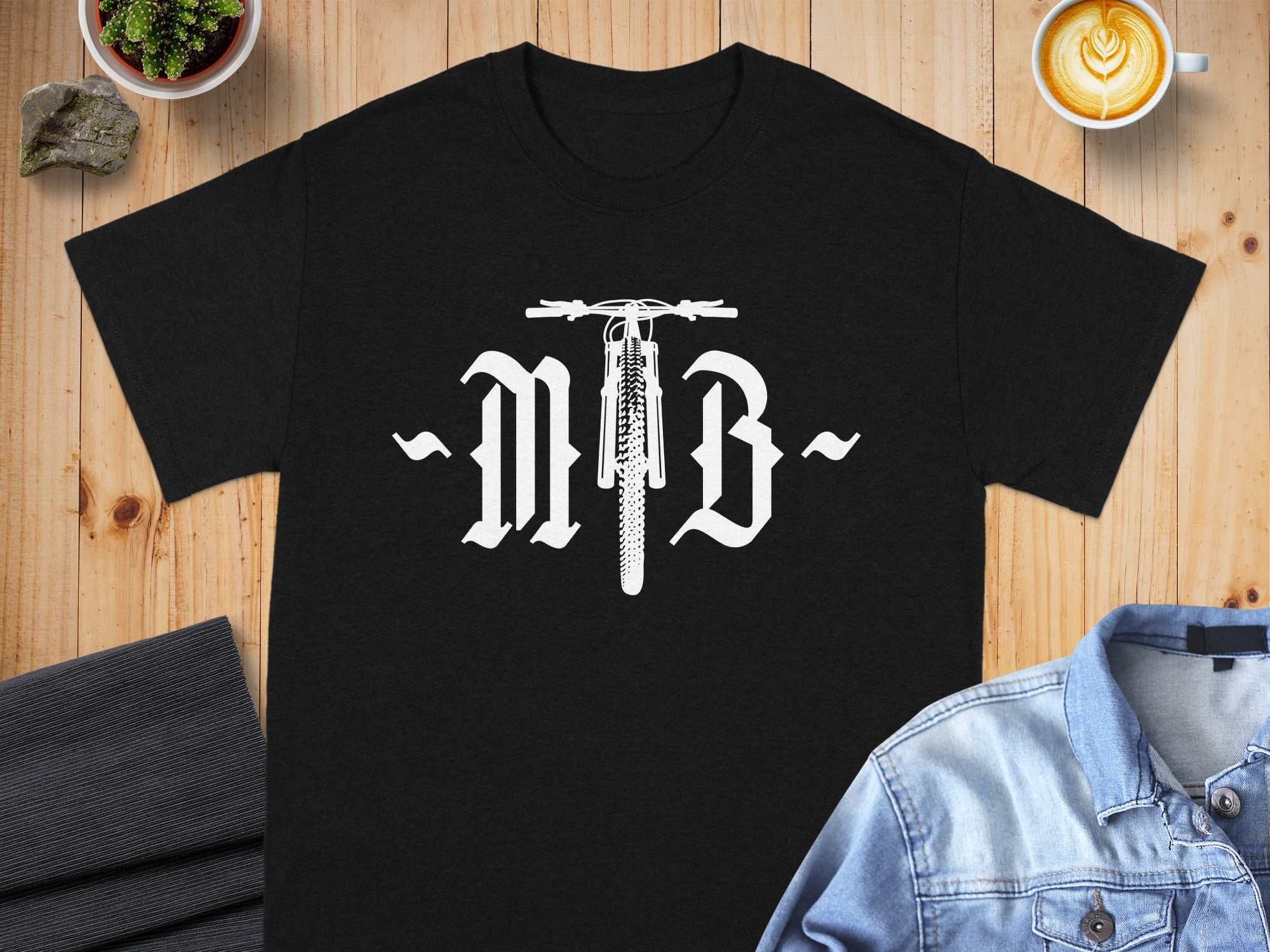 Black t-shirt with white "MB" text and mountain bike illustration.