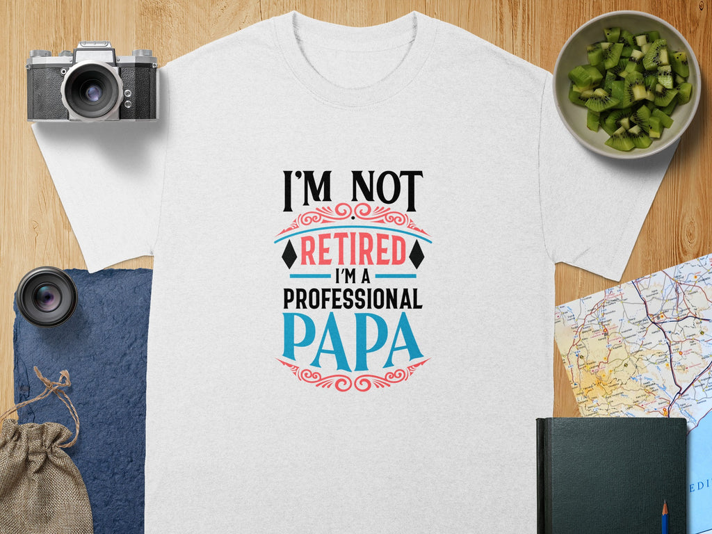 White t-shirt with "I'M NOT RETIRED I'M A PROFESSIONAL PAPA" graphic.