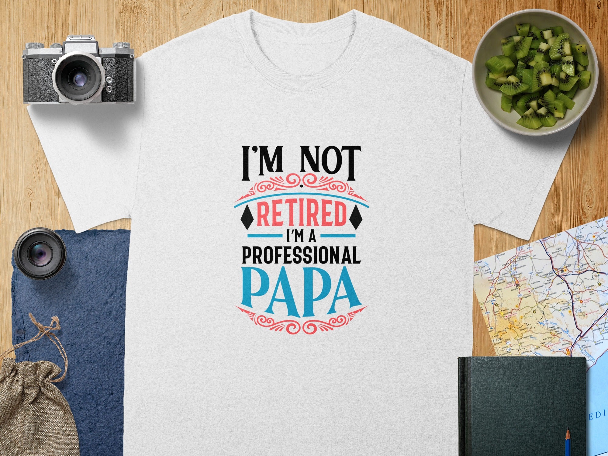 White t-shirt with "I'M NOT RETIRED I'M A PROFESSIONAL PAPA" graphic.