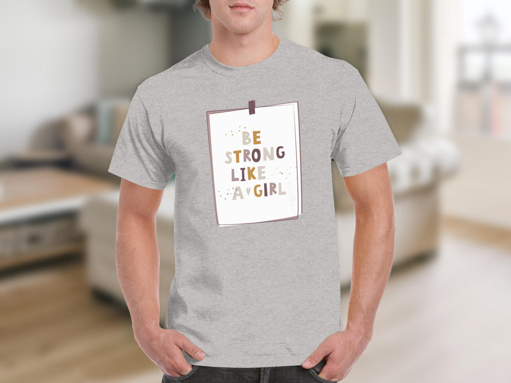 Grey t-shirt with "BE STRONG LIKE A GIRL" text on a white square design.