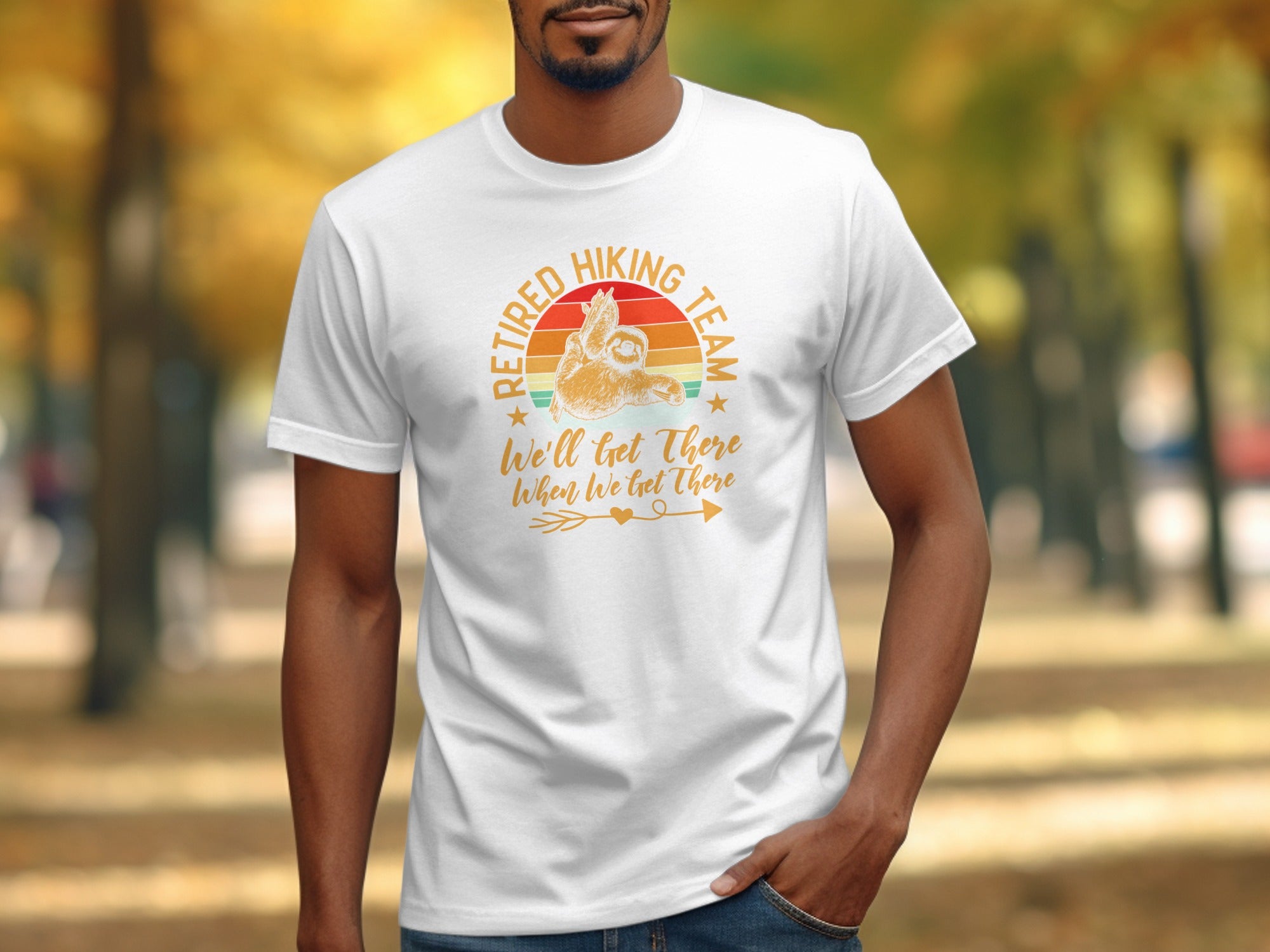 White t-shirt with a sloth graphic reading "Retired Hiking Team We'll Get There When We Get There."