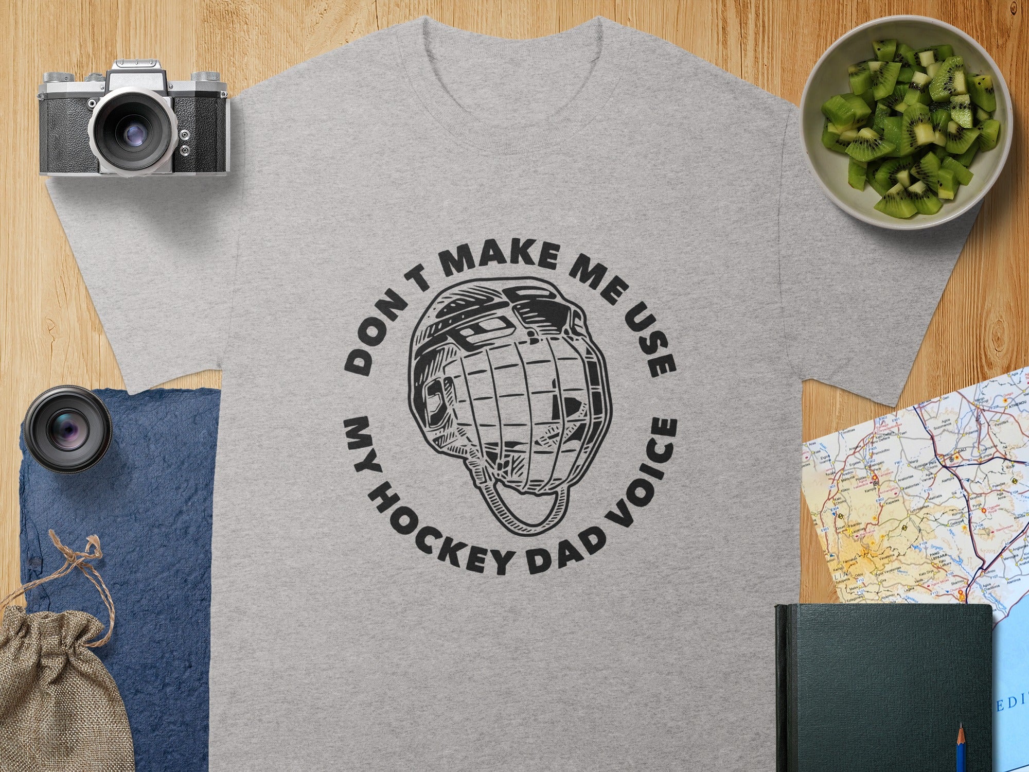 Grey t-shirt with "Don't Make Me Use My Hockey Dad Voice" text and hockey helmet graphic.