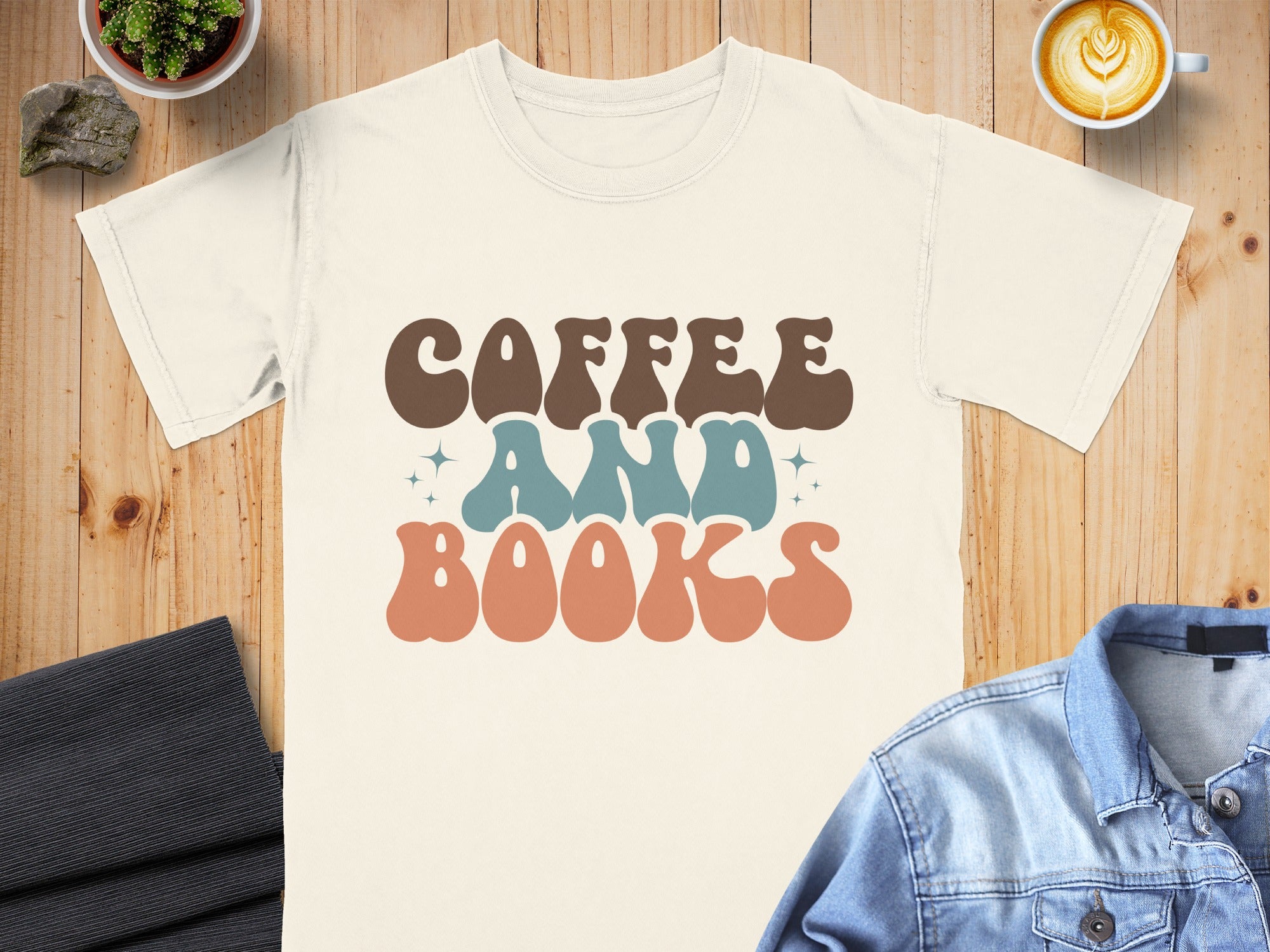 Cream t-shirt with retro "Coffee and Books" text in brown, teal, and coral.