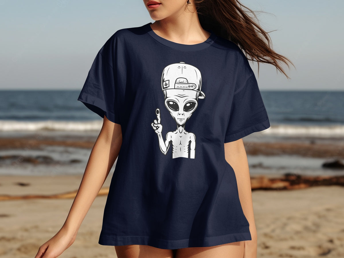Navy t-shirt with white alien graphic wearing a baseball cap and raising a finger.