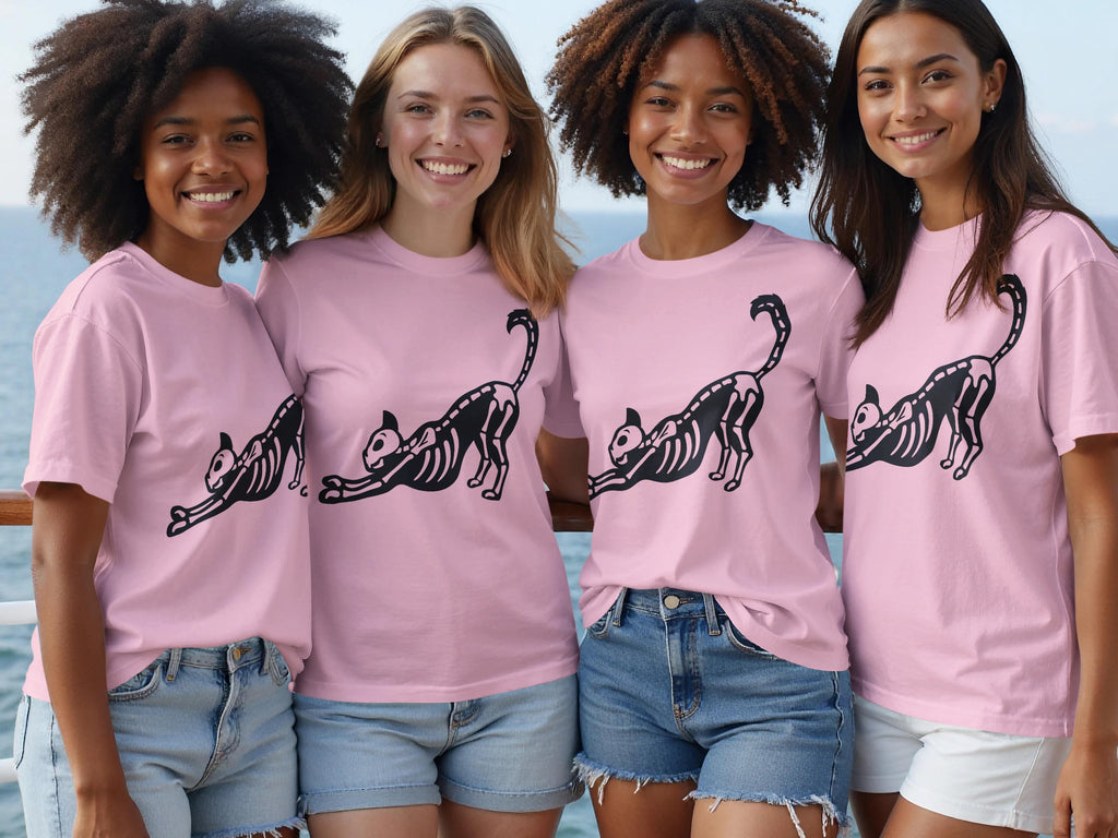 Four women wear pink t-shirts with a black skeleton cat graphic.