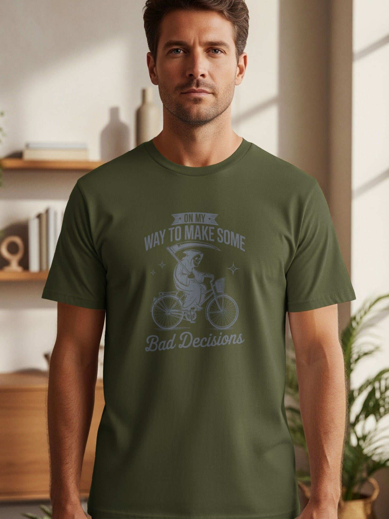 Green t-shirt with grim reaper on a bicycle and text "On My Way To Make Some Bad Decisions".